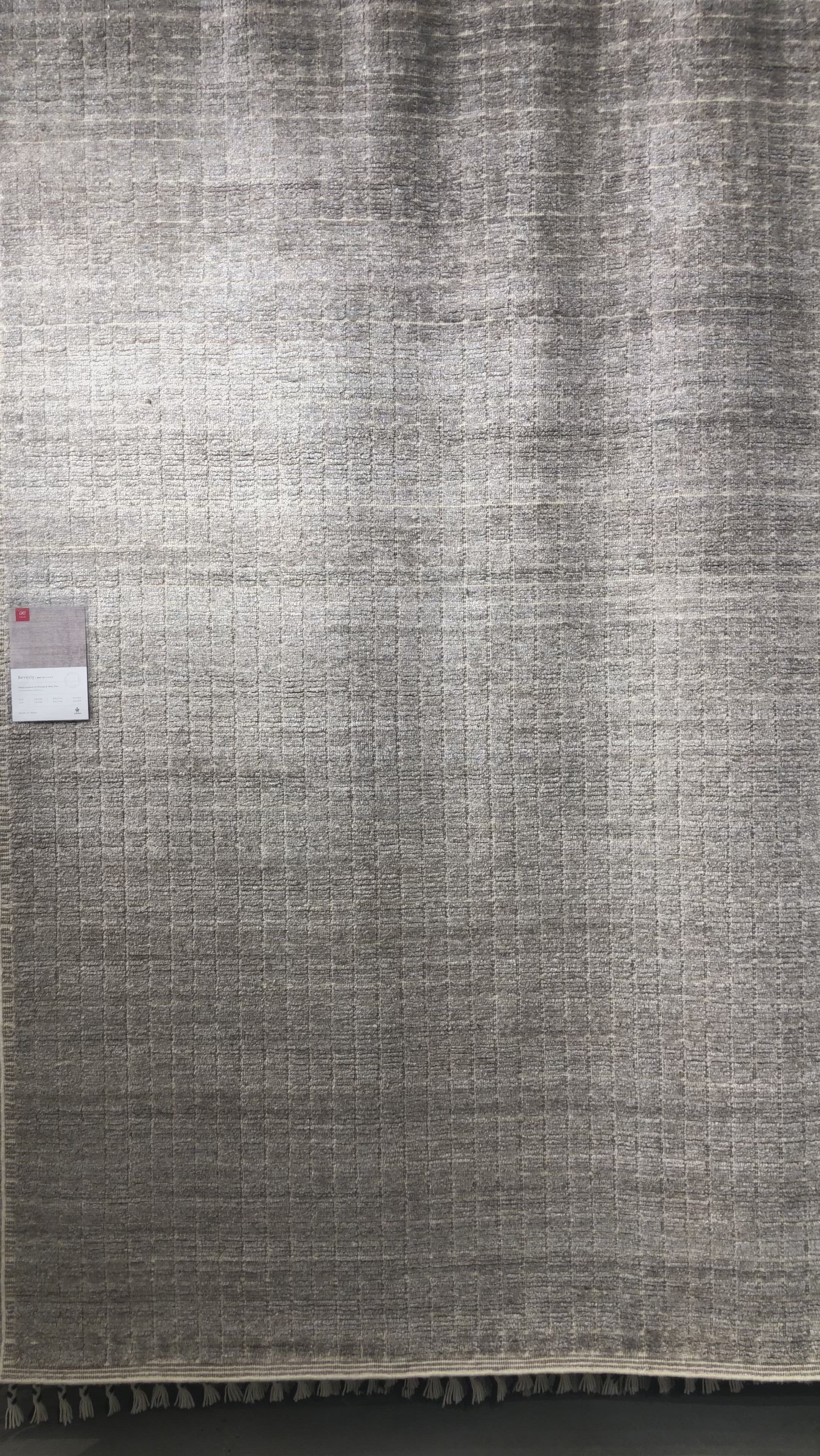 Modern and refined, the Beverly Stone rug by Loloi is hand-loomed by master artisans of viscose and wool pile. Clean lines and minimalist hues allow you to layer Beverly into any room.  Hand Loomed 45% Viscose | 26% Wool | 20% Cotton | 7% Polyester | 2% Other Fibers BEV-01 Stone