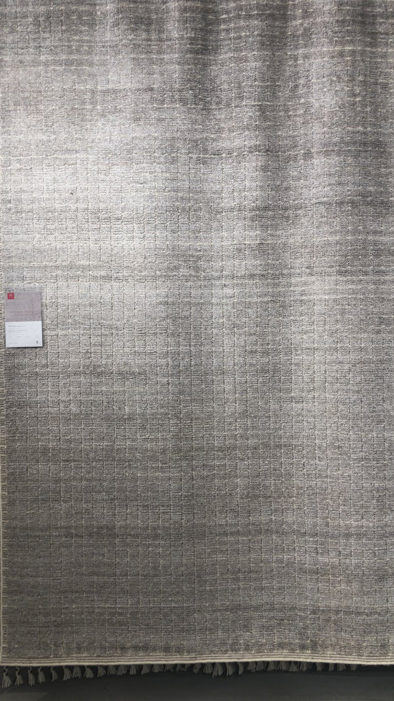 Modern and refined, the Beverly Stone rug by Loloi is hand-loomed by master artisans of viscose and wool pile. Clean lines and minimalist hues allow you to layer Beverly into any room.  Hand Loomed 45% Viscose | 26% Wool | 20% Cotton | 7% Polyester | 2% Other Fibers BEV-01 Stone