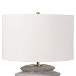 This Canyon Ceramic Table Lamp has an earthy, yet bold feel with its natural linen shade and grey ceramic body. This is a statement in any bedroom or living room.   Size: 18"w x 18"d x 24.5"h Material: Ceramic