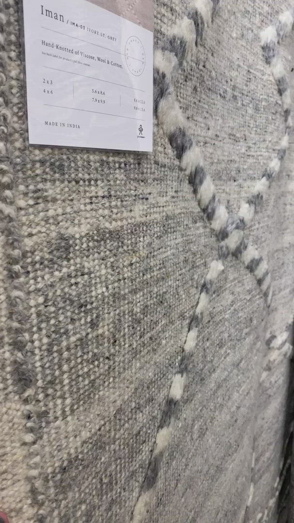 A new take on Moroccan style rugs, the Iman Collection is hand-knotted of 100% wool pile by skilled artisans in India. The surface features linear and braided details, creating tonal variations that make each piece unique. Plus, each design is finished with playful fringe.  Hand Knotted 100% Wool Pile IMA-03 Ivory / Light Grey