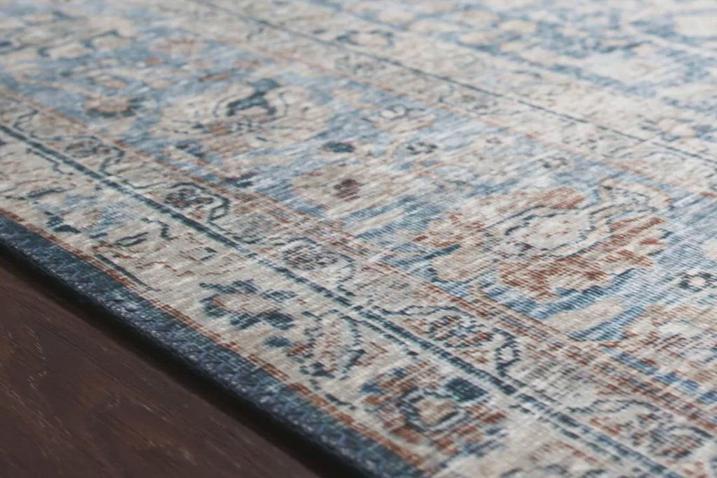The Layla Collection is traditional and timeless, with a beautiful lived-in design that captures the spirit of an old-world rug. This traditional power-loomed rug is crafted of 100% polyester with a classic and sophisticated color palette and subtle patina.  Power Loomed 100% Polyester LAY-07 Blue/Tangerine