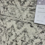 Hand-knotted in India of 100% wool, the Amara Ivory/Taupe Area Rug creates a casual yet refined vibe with high-end appeal. With shades of ivory, taupe, and black, this is a gorgeous rug to showcase in your living room, entryway, bedroom, or other high traffic area.   Hand Knotted 100% Wool AMM-04 Ivory/Taupe
