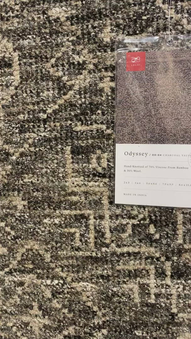 Drawing inspiration from tribal influences, the Odyssey Collection combines relaxed linear pattern with a sophisticated color palette. Each Odyssey rug, which is hand-knotted of wool and viscose from bamboo, is crafted entirely by hand by master artisans in India.  Hand Knotted 70% Viscose from Bamboo | 30% Wool OD-04 Charcoal/Taupe