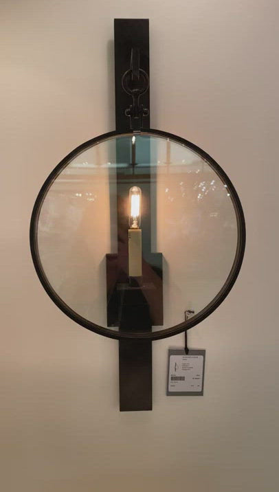 The Alice Aged Iron Sconce by Visual Comfort has a unique circular covering that showcases the single candle placed in the middle. Finished in Aged Iron, this is a gorgeous sconce to add in your living room, bedroom,  or other area needing an attractive source of light.  Designer: Suzanne Kasler