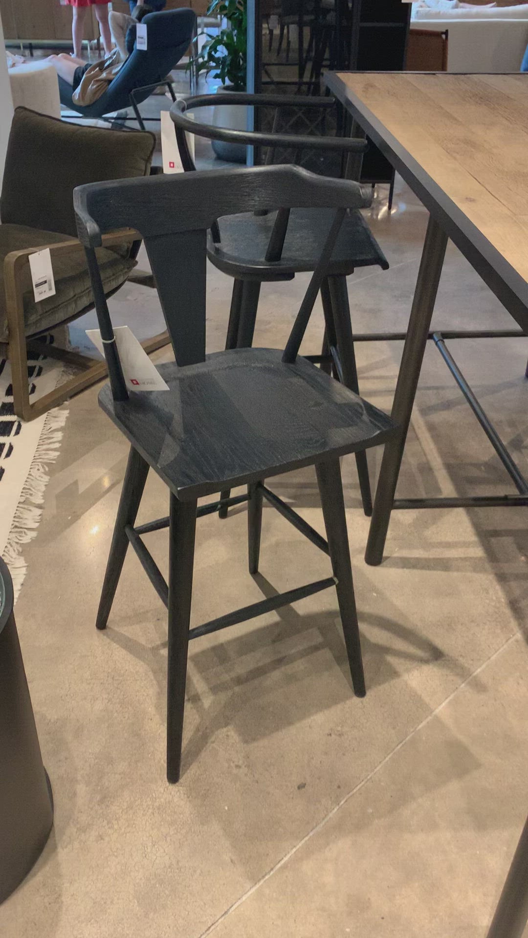 A fresh, bar-style take on mid-century Windsor seating is found in this Ripley Bar + Counter Stool - Black Oak. Featuring a bowed, sculptural silhouette and soft black finish to highlight the natural grain of weathered oak.