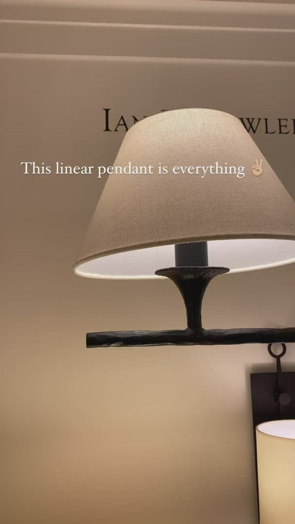 The Cesta Linear Chandelier by Visual Comfort is finished in aged iron with a linen shade. We love the timeless look it brings to a living room, dining room, or other large area.   Designer: Ian K. Fowler