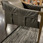 The Bauer Ebony Leather Chair is a favorite lush seating of ebony top-grain leather that fastens to grey birch framing via trend-forward buckles. The angular arms honor mid-century design, adding a throwback feel to a cutting-edge look.  Overall Dimensions: 27.00"w x 35.00"d x 29.00"h