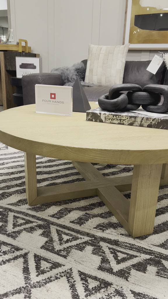 Made from solid natural nettlewood, an open cross-style base supports a thick, rounded tabletop finished with a soft hand on this Liad Coffee Table - Natural Nettlewood. We'd love to see this in your living room or lounge area! Amethyst Home provides interior design, new home construction design consulting, vintage area rugs, and lighting in the San Diego metro area.