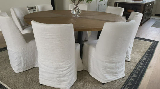 The Craig Dining Chair is featured in a gorgeous white linen slip cover in a Belgian wrinkle.   LINEN FABRIC AND BIRCH FRAME WHITE Size: 19"l x 23"d x 35"h Seat Height: 20"h