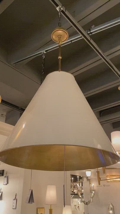 The Goodman Large Hanging Lamp by Visual Comfort gives us all the industrial and farmhouse vibes. Available in four different finishes, this looks gorgeous hanging over a kitchen island, sink, or other large area.  Designer: Thomas O'Brien