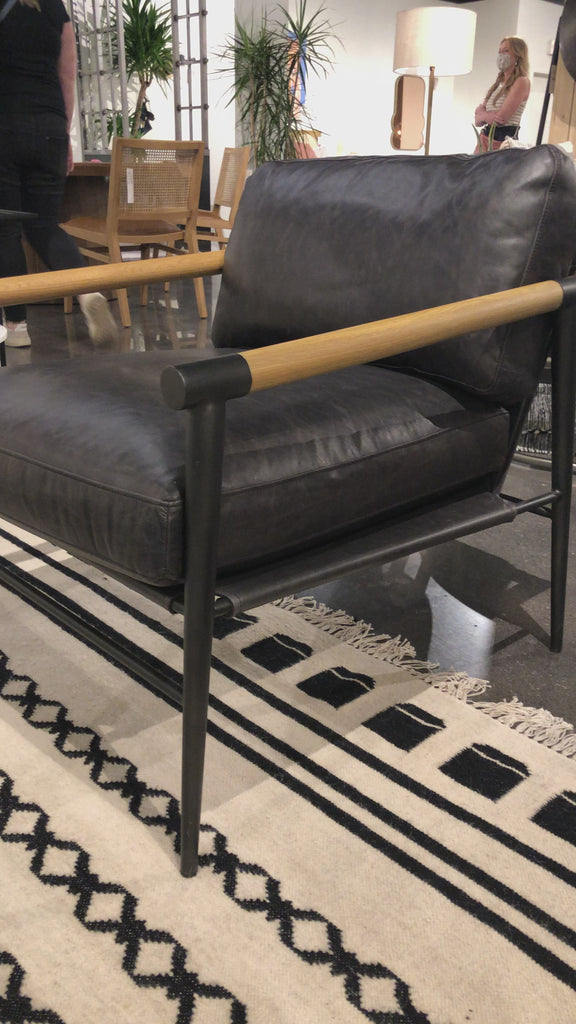 This Rowen Chair - Sonoma Black has buttery black seating of top-grain leather, with angular arms of exposed oak providing fresh contrast. A comfy, modern chair to add to any living room, bedroom, or other area.   Overall Dimensions: 27.50"w x 32.00"d x 31.00"h