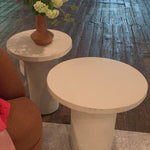 Made from plaster-molded concrete, a pedestal-style base supports a rounded tabletop of smooth, white-finished concrete in this Parra Low End Table - Plaster Molded Concrete. This brings a clean, adobe-inspired vibe to any living room or lounge area. Pair with the matching High End Table for a staggered look!   Overall Dimensions: 20.00"w x 20.00"d x 18.00"h