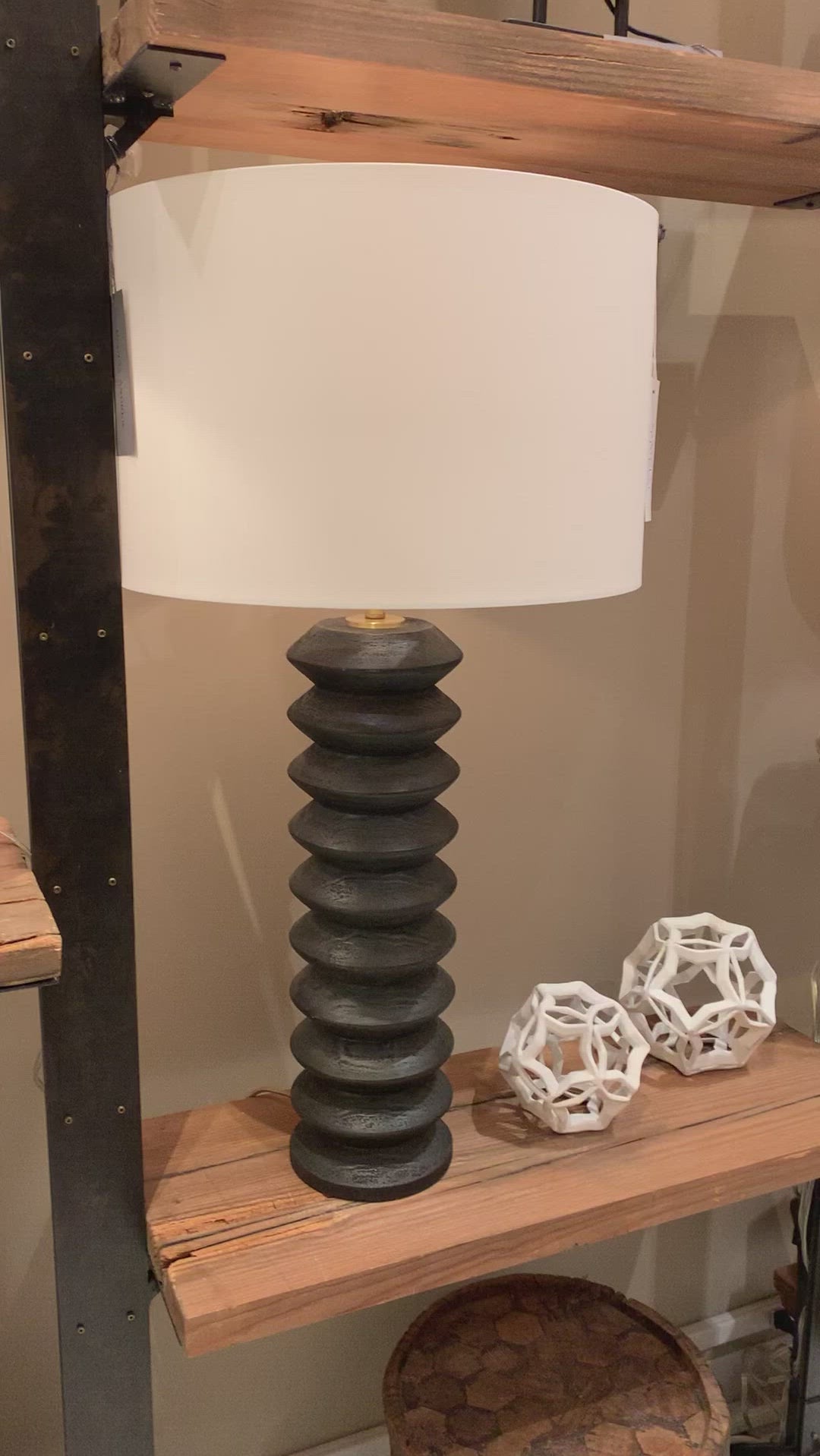 We love the groves found on this Accordion Table Lamp. Made from birch wood with a pronounced grain and ebony finish, this brings a sleek, modern look to any living room, bedroom, or other space.   Size: 17"w x 17"d x 33"h  Shade Dims: 17 x 17 x 11