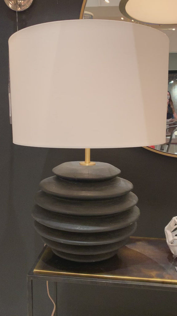 We love the groves found on this Accordion Table Lamp Round. Made from birch wood with a pronounced grain and ebony finish, this brings a sleek, modern look to any living room, bedroom, or other space.   Size: 18"w x 18"d x 26"h  Shade Dims: 18 x 18 x 11