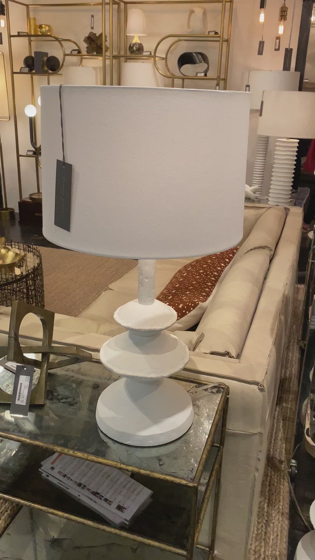 We love the unique base of this Hope Table Lamp. The matte white finish gives it clean look, completing the look for any living room, bedroom, or other space.   Size: 16"w x 16"d x 28"h  Shade Dims: 15 x 16 x 10.5