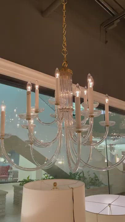 The crystal shade and slim, curved layers of this Wharton Chandelier by Visual Comfort make it an eye catcher for any living room, entry way, or other large area.  Designer: AERIN