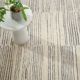 Inspired by substrate layers of sandstone sediments that chronicle the millennia, this luxurious, irregularly striped wool rug will stand the test of time. The subtle degradations of a natural undyed fleece pile enhance the finely observed irregular striping in a softly mineral palette. The subtle beauty of the higher sheared tufts emphasizes the contrast of the densely looped stripes. Amethyst Home provides interior design, new construction, custom furniture, and area rugs in the Winter Garden metro area.