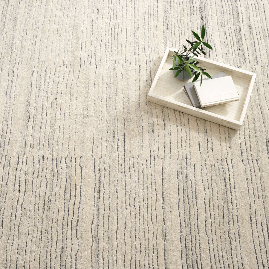 Inspired by substrate layers of sandstone sediments that chronicle the millennia, this luxurious, irregularly striped wool rug will stand the test of time. The subtle degradations of a natural undyed fleece pile enhance the finely observed irregular striping in a softly mineral palette. The subtle beauty of the higher sheared tufts emphasizes the contrast of the densely looped stripes. Amethyst Home provides interior design, new construction, custom furniture, and area rugs in the San Diego metro area.
