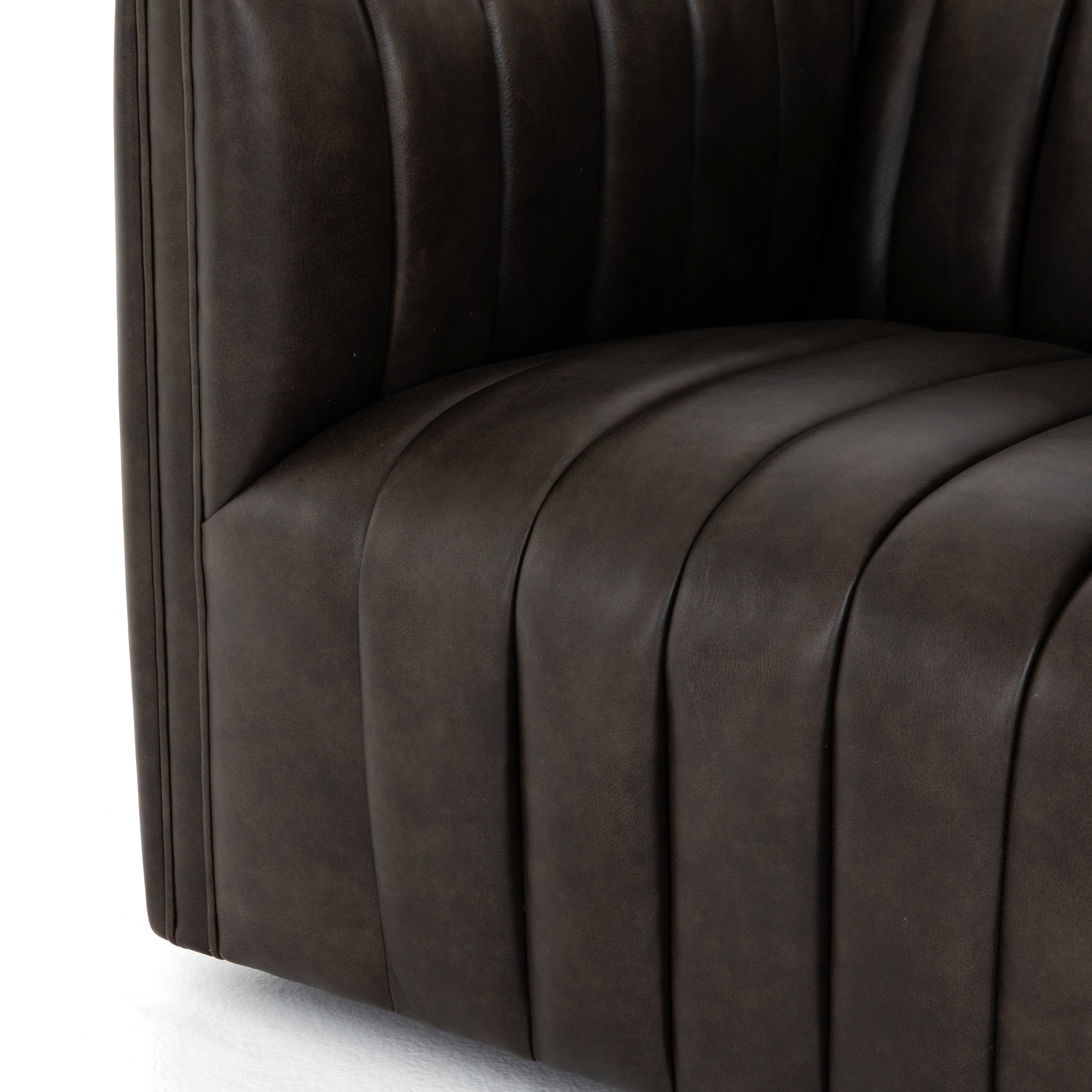 You will love the dramatic channeling and deep brown hue of this Augustine Deacon Wolf Swivel Chair. The swivel feature sets this apart from other chairs and is a great choice for any living room or media room. This chair is comfort wrapped in soft leather making this everyone's favorite chair.
