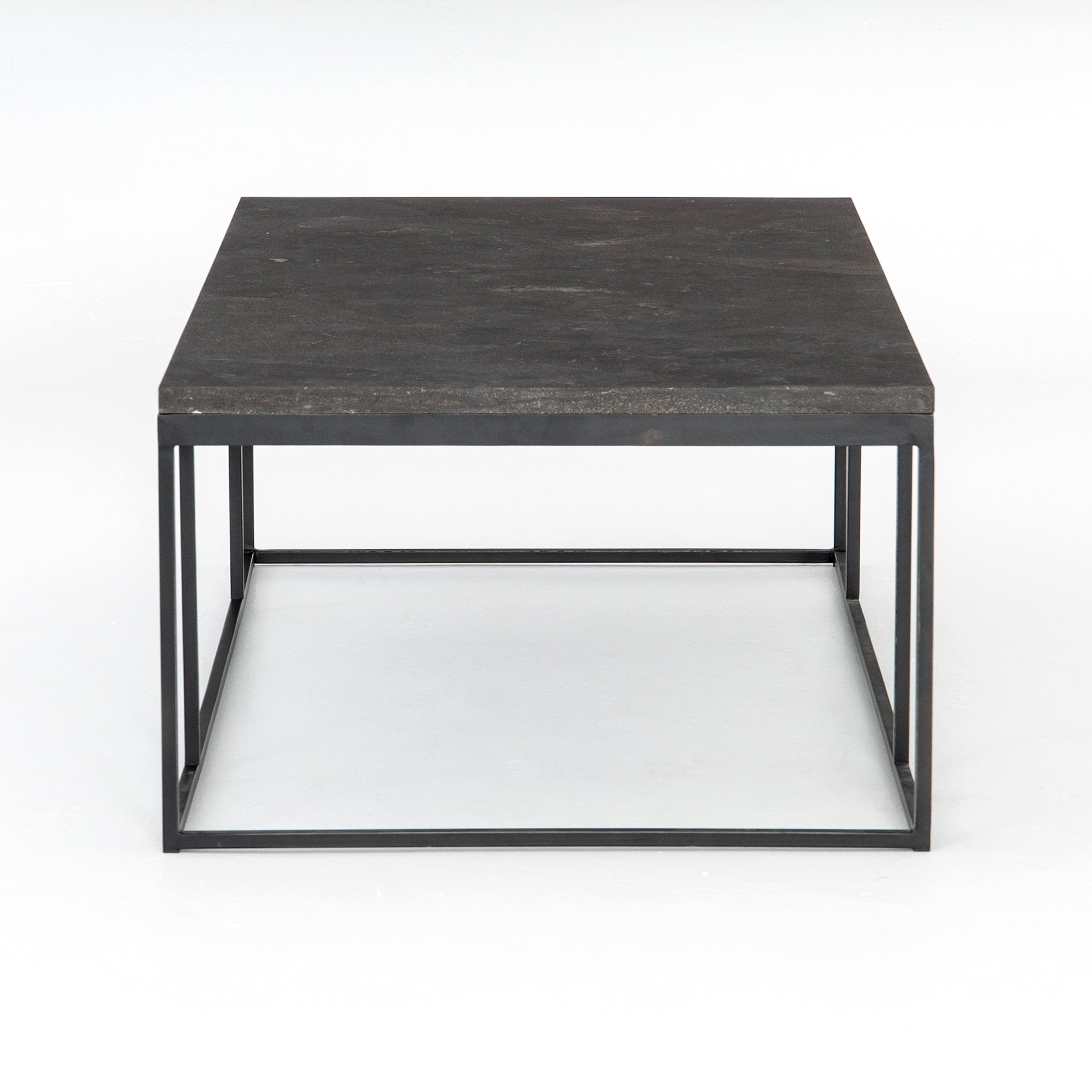 Spare beauty, casual elegance with the Harlow Bluestone Small Coffee Table. A gunmetal Parson's base with hand-rubbed, dimensional edges supports a rough-hewn bluestone slab that feels found and perfectly placed.  Size: 60"w x 28"d x 17"h Materials: Iron, Limestone