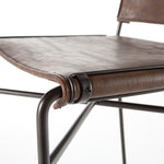 Slim lines and mixed materials combine for ample comfort. Architecturally inspired steel tubing is graced by simply contoured distressed brown seating.  Overall Dimensions: 20.75"w x 24.25"d x 44.00"h Seat Depth: 15.25" Seat Height: 30.25"