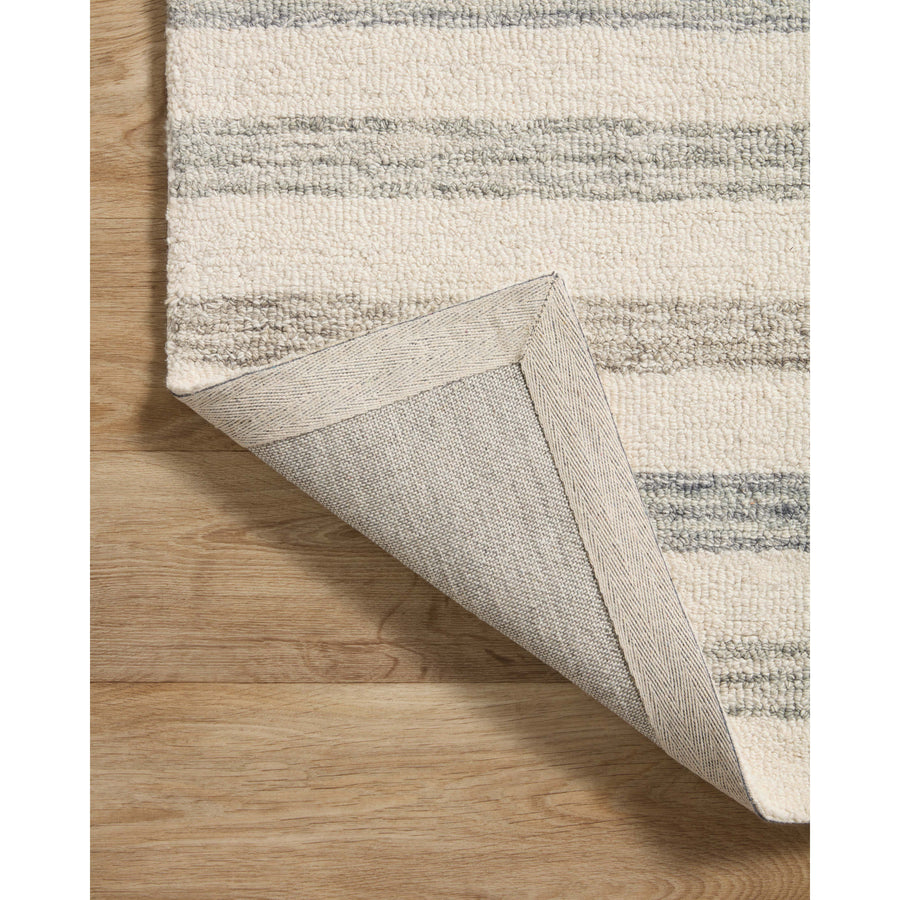 Known for its durability, the Chris Ivory / Slate hooked wool rug is a smart choice for any room in your home that gets lots of love. The subtle, tonal stripes remind us of our favorite California cool hemp rugs. Amethyst Home provides interior design services, furniture, rugs, and lighting in the Monterey metro area.