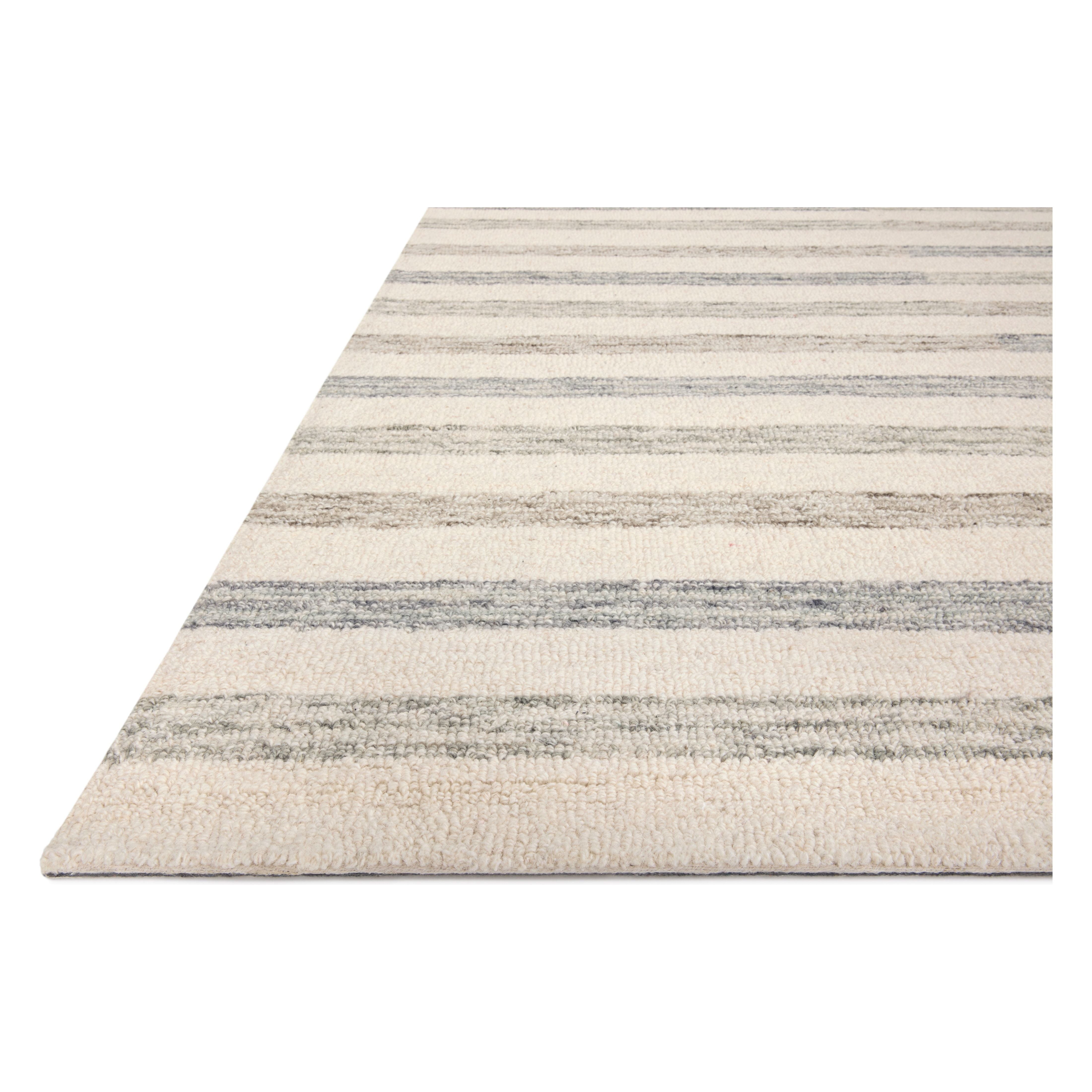Known for its durability, the Chris Ivory / Slate hooked wool rug is a smart choice for any room in your home that gets lots of love. The subtle, tonal stripes remind us of our favorite California cool hemp rugs. Amethyst Home provides interior design services, furniture, rugs, and lighting in the Seattle metro area.