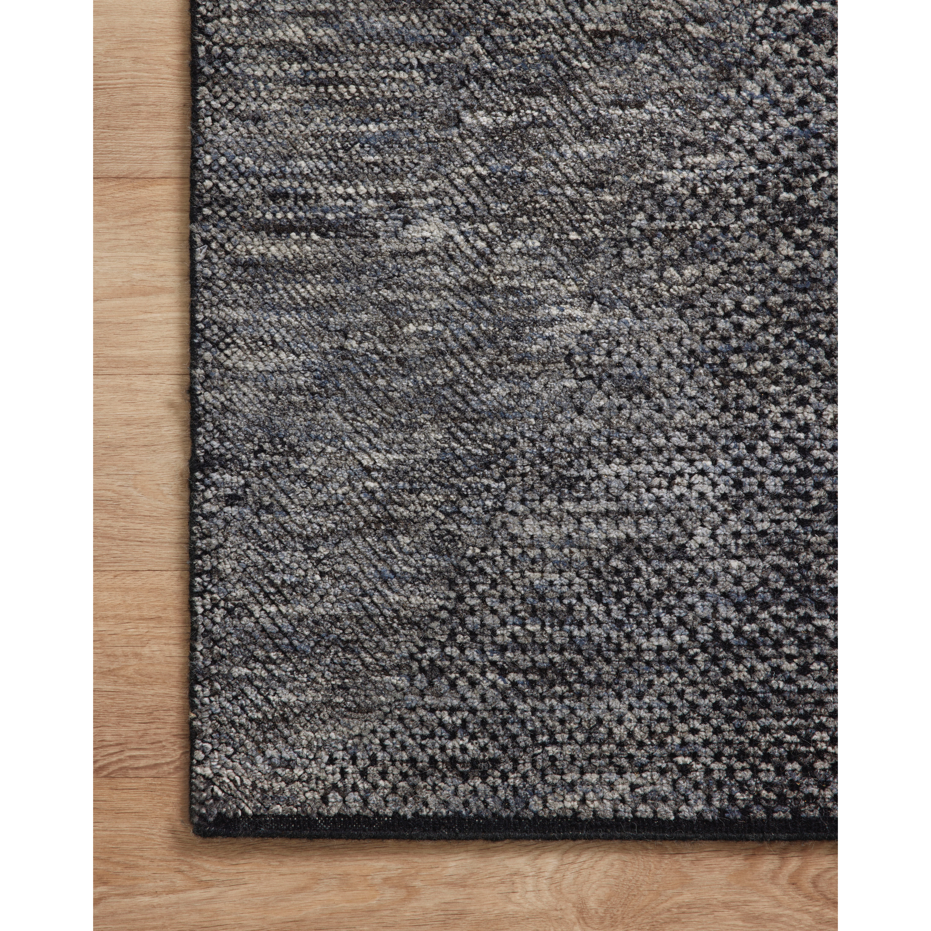 The Collins Amber Lewis x Loloi COI-01 AL Charcoal / Denim rug for Amber Lewis x Loloi is hand-knotted of wool and cotton by skilled artisans in India and GoodWeave-Certified. Collins features varying knotting techniques interwoven to create a uniquely texture pattern. Amethyst Home provides interior design, new construction, custom furniture, and rugs for the Winter Park and Orlando, Florida metro area.