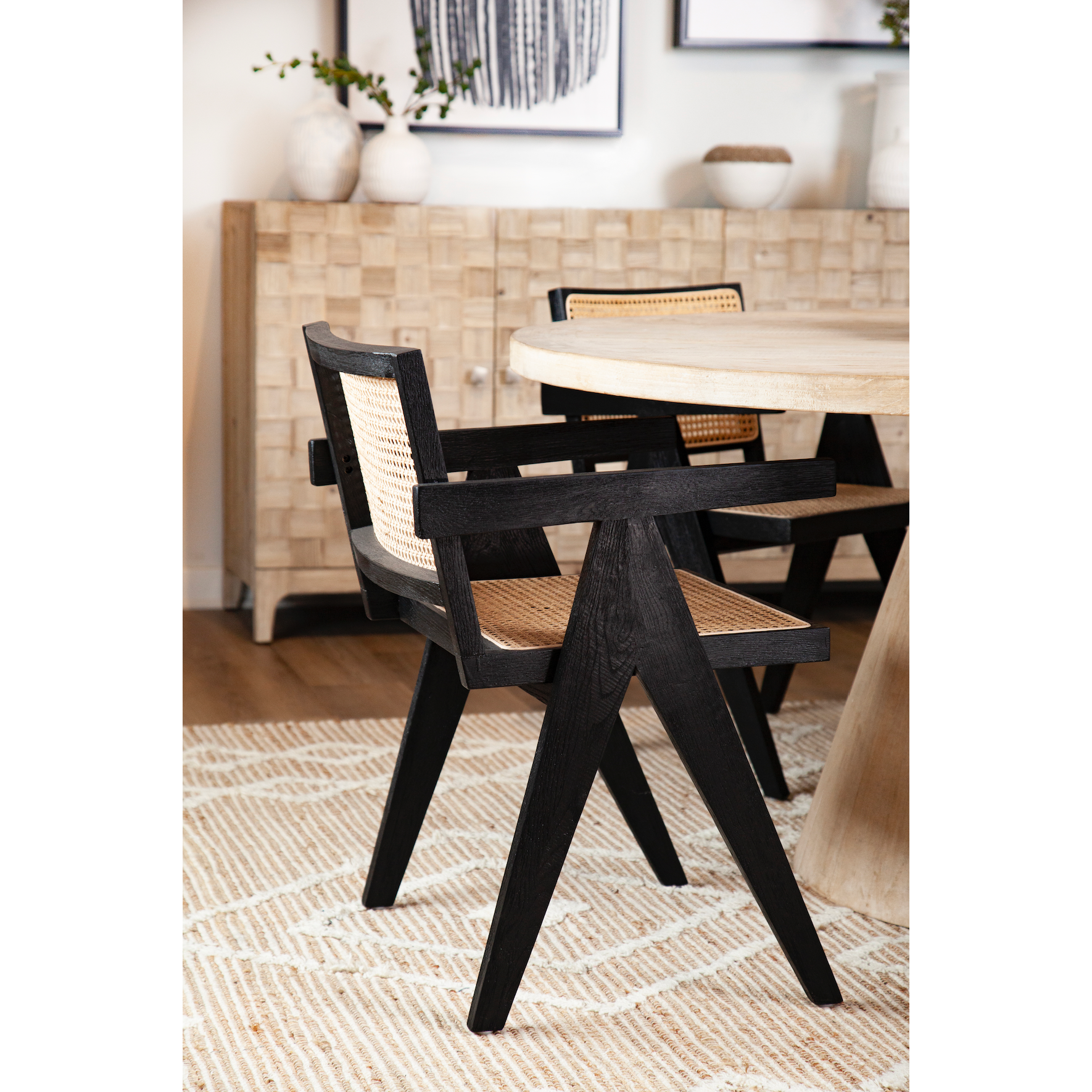 Finished in an antique black and natural rattan, this beautiful Norwich dining chair is modern with a tropical flare. Amethyst Home provides interior design, new construction, custom furniture, and area rugs in the Denver metro area.