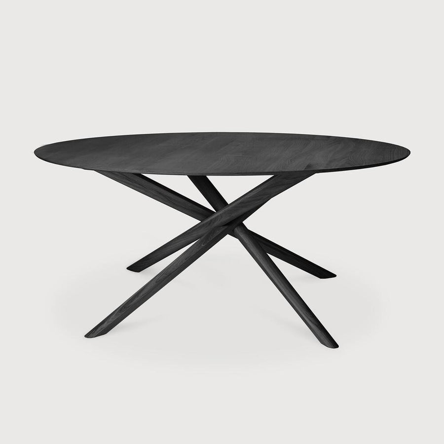 The Mikado dining table's sculptural character is the result of a quest to find a balance between functionality and stability. The legs interlock like a well-thought-out puzzle, arranged under a solid round top. Designed by Alain van Havre. Amethyst Home provides interior design, new home construction design consulting, vintage area rugs, and lighting in the Kansas City metro area.