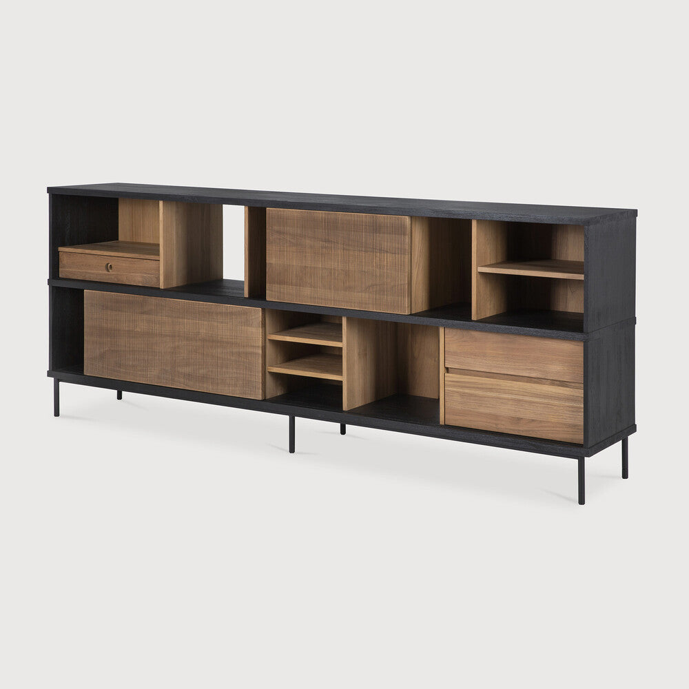 The Oscar sideboard in solid teak by Alain van Havre is the perfect multi-tasker: its open spaces can be used to exhibit personal objects, whereas the sliding doors offer the option of organizing documents out of sight. Notice the exceptional grooves in the doors: each narrow groove was carefully hand carved, making every Oscar piece unique. Amethyst Home provides interior design, new home construction design consulting, vintage area rugs, and lighting in the Salt Lake City metro area.