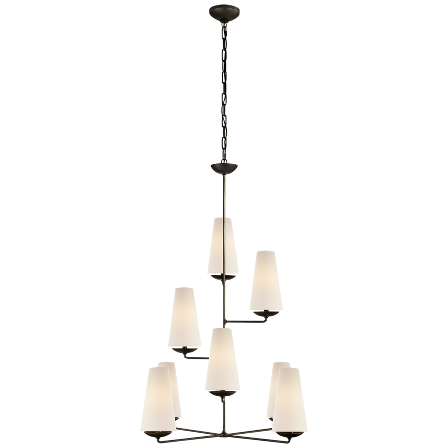 The Fontaine Vertical Chandelier by Visual Comfort has a classy, layered look. The linen shades brings a warm light to any living room, dining room, or other large area  Designer: AERIN