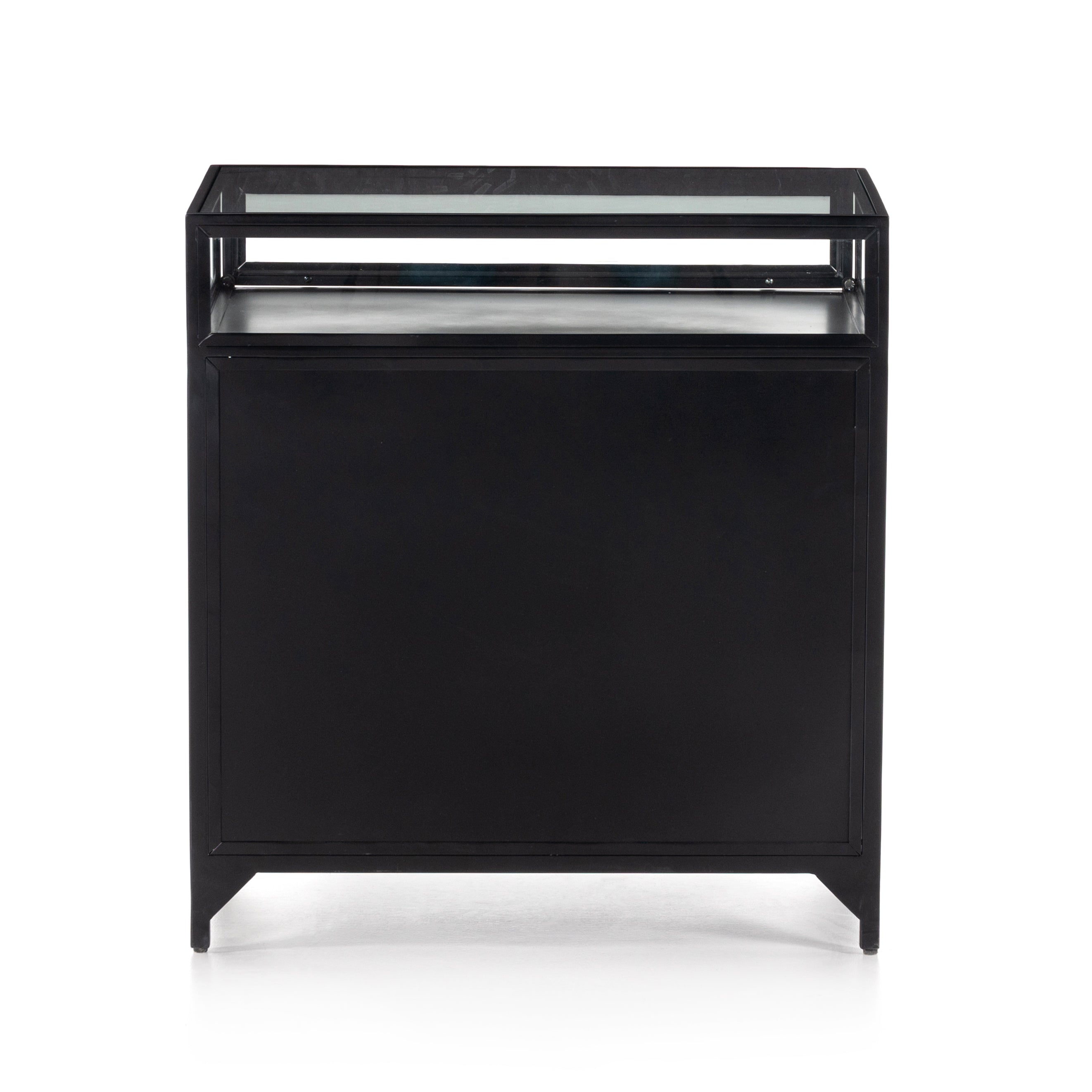 This Shadow Box Nightstand is finished in a gorgeous matte black. We love that the glass top allows you to showcase your favorite jewelry or family keepsake, while the two spacious drawers give you storage space. The knobs are finished in bronze to give this piece a sleek contrast.  Overall Dimensions: 28.00"w x 17.75"d x 30.00"h Materials: Iron, Tempered Glass, Glass