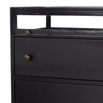 This Shadow Box Nightstand is finished in a gorgeous matte black. We love that the glass top allows you to showcase your favorite jewelry or family keepsake, while the two spacious drawers give you storage space. The knobs are finished in bronze to give this piece a sleek contrast.  Overall Dimensions: 28.00"w x 17.75"d x 30.00"h Materials: Iron, Tempered Glass, Glass