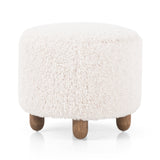 Place this round Aniston Andes Natural Ottoman just about anywhere for a subtle retro vibe. Upholstered in a faux Mongolian shearling with a high pile fur. Parawood legs are wirebrushed for a warm, vintage feel. Amethyst Home provides interior design services, furniture, rugs, and lighting in the Miami metro area.