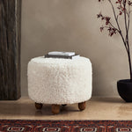 Place this round Aniston Andes Natural Ottoman just about anywhere for a subtle retro vibe. Upholstered in a faux Mongolian shearling with a high pile fur. Parawood legs are wirebrushed for a warm, vintage feel. Amethyst Home provides interior design services, furniture, rugs, and lighting in the Salt Lake City metro area.