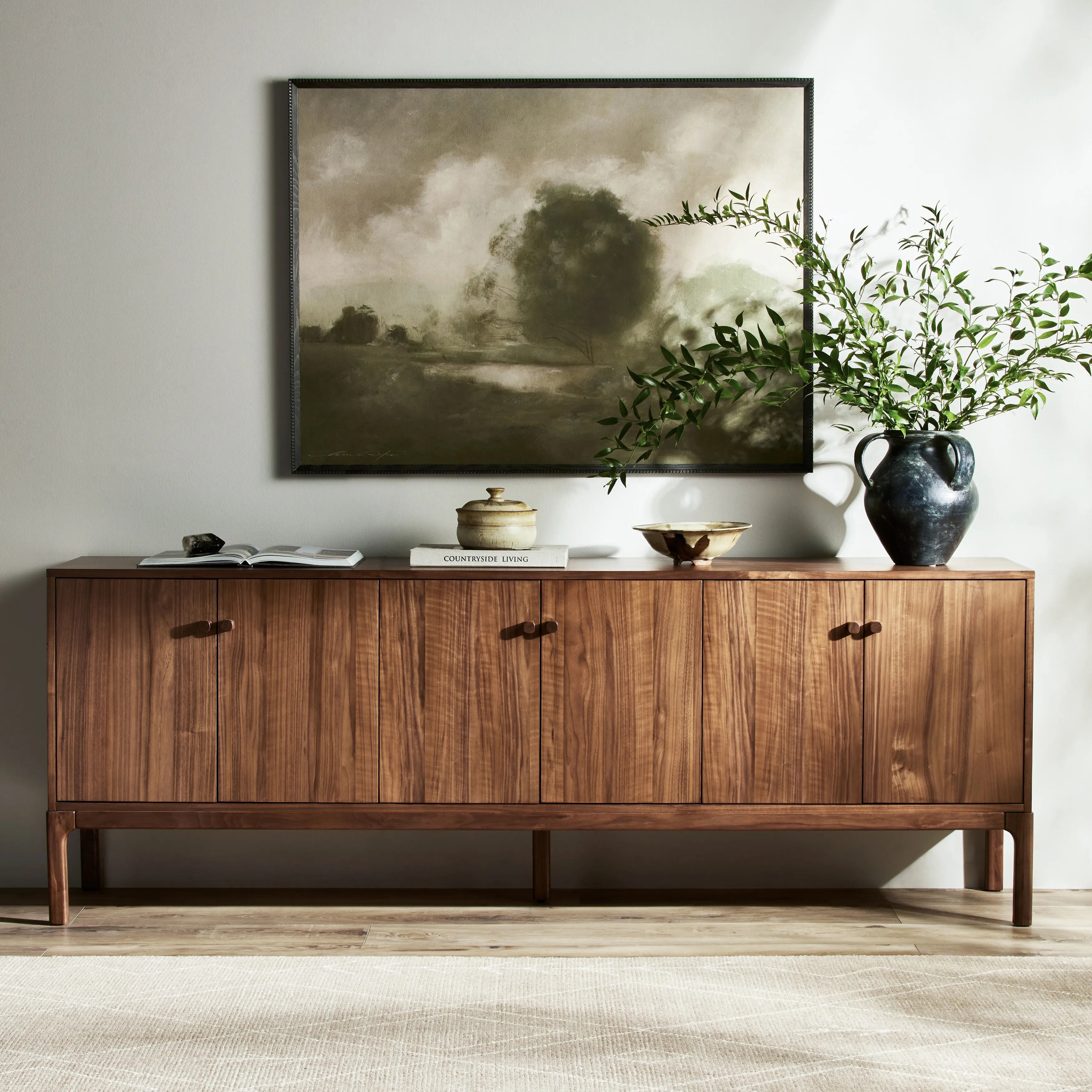 Inspired by campaign-style furniture of the 1800s â€” packable pieces first designed for traveling military use â€” a simply shaped sideboard of natural walnut features a subtly inset top and rounded legs, finished with wooden hardware Amethyst Home provides interior design, new home construction design consulting, vintage area rugs, and lighting in the Salt Lake City metro area.