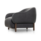 This elevated arm chair features a clean top piece that partially overlaps its bottom counterpart and seamlesssly blends the back cushion into the armrests in one fluid form. The seat's legs appear to extend from the seat and back, adding architectural interest. Amethyst Home provides interior design, new home construction design consulting, vintage area rugs, and lighting in the Portland metro area.