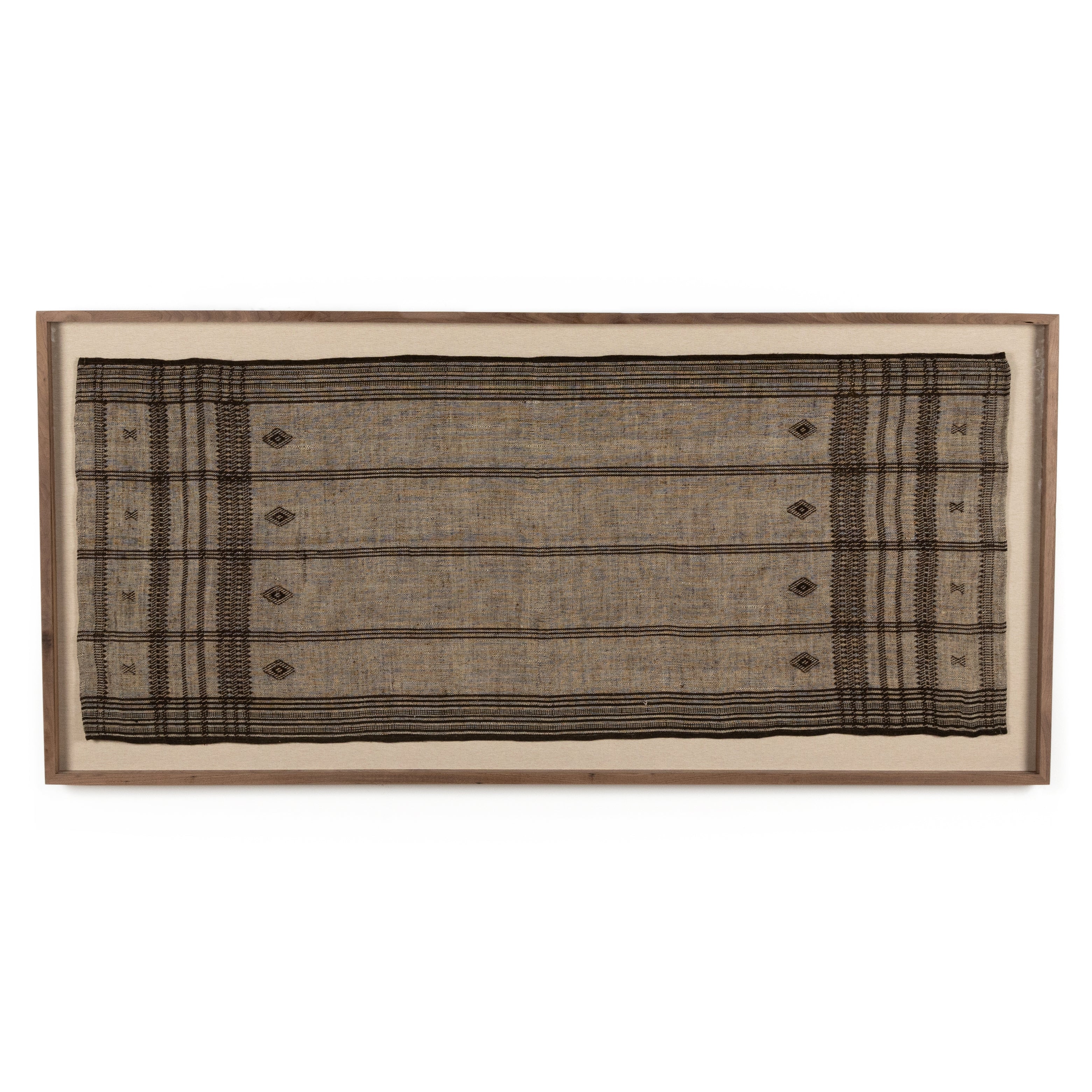 A Bhujodi-style textile is framed within rustic walnut for a gallery-quality look. Handmade in Austin, Texas. Amethyst Home provides interior design, new home construction design consulting, vintage area rugs, and lighting in the Tampa metro area.