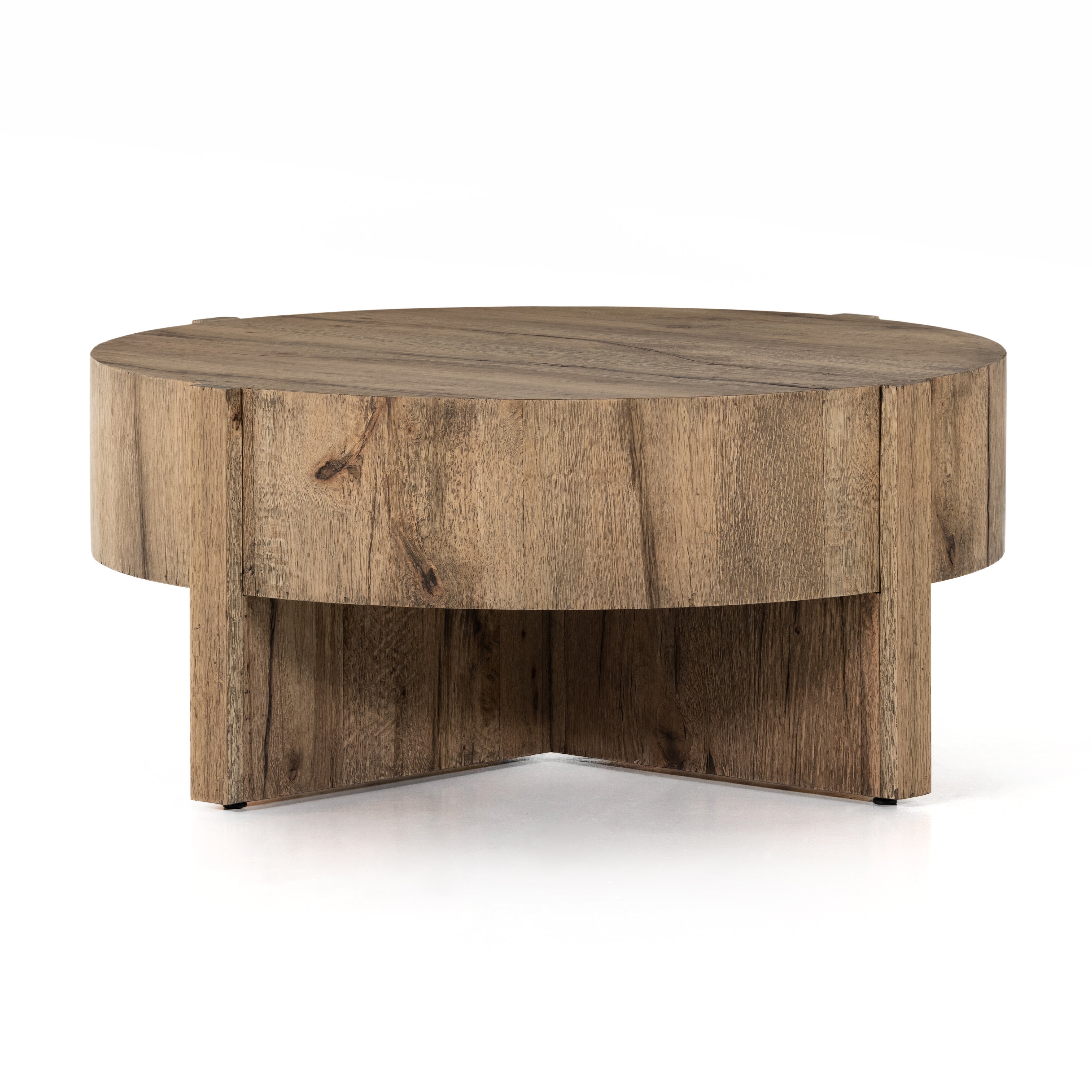 An organic-spirited statement piece. A drum-style coffee table of character-rich oak and veneers rests within a sculptural cradle base of matching rustic oak with beautiful highs and lows. Amethyst Home provides interior design, new construction, custom furniture, and area rugs in the Des Moines metro area.