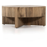 An organic-spirited statement piece. A drum-style coffee table of character-rich oak and veneers rests within a sculptural cradle base of matching rustic oak with beautiful highs and lows. Amethyst Home provides interior design, new construction, custom furniture, and area rugs in the Newport Beach metro area.
