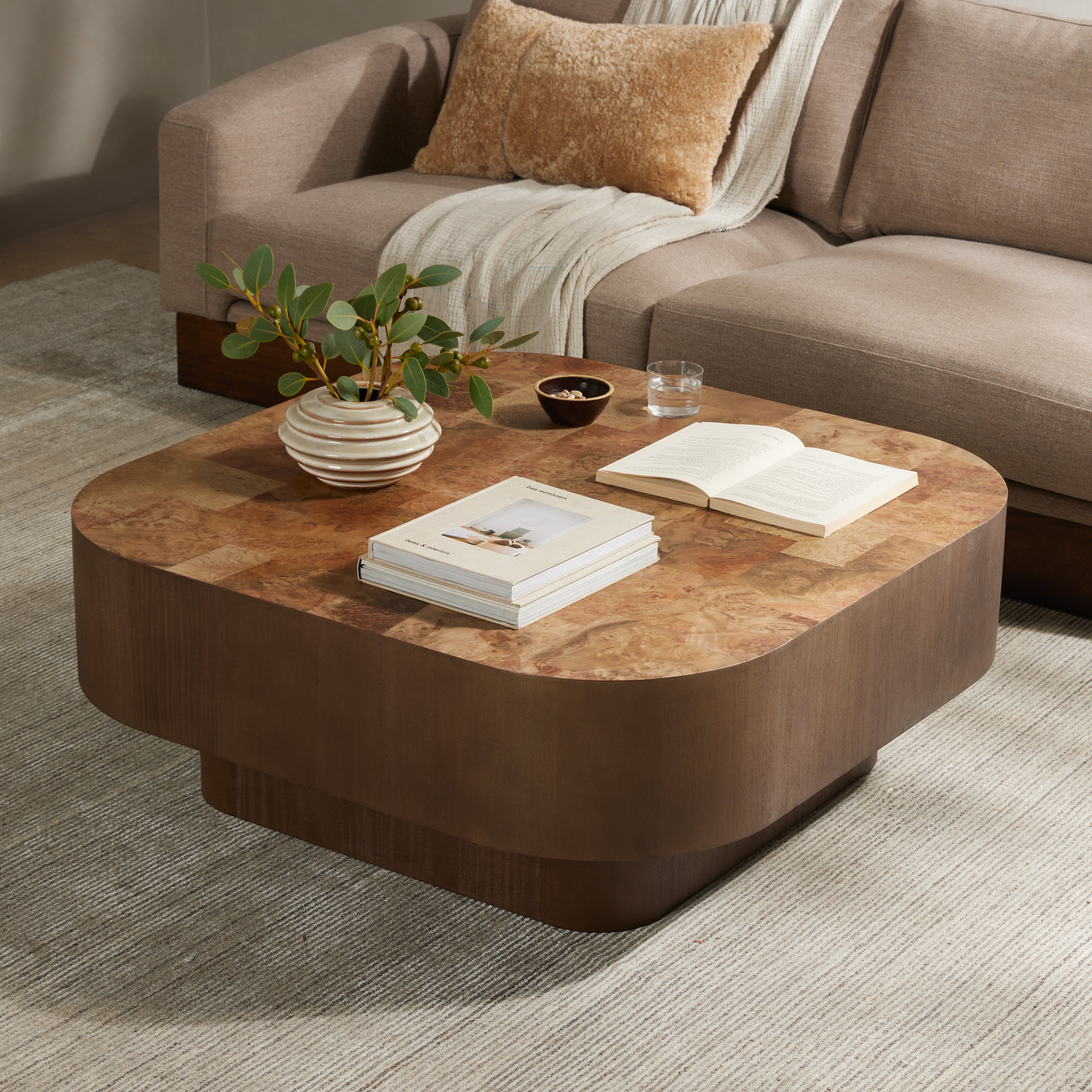 Made from warm-toned burl, a soft-squared tabletop features a patchwork pattern to bring novel movement to the modern coffee table. Veneer sides and an inset base complete a beautifully light look. Amethyst Home provides interior design, new construction, custom furniture, and area rugs in the Omaha metro area.