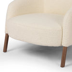 An easy, go-with-anything accent chair in a classic shape and elevated fabric. Upholstered in a soft vintage-inspired fabric with boucle yarns throughout for added texture. Finished with nettlewood spindle legs.Collection: Allsto Amethyst Home provides interior design, new home construction design consulting, vintage area rugs, and lighting in the Charlotte metro area.