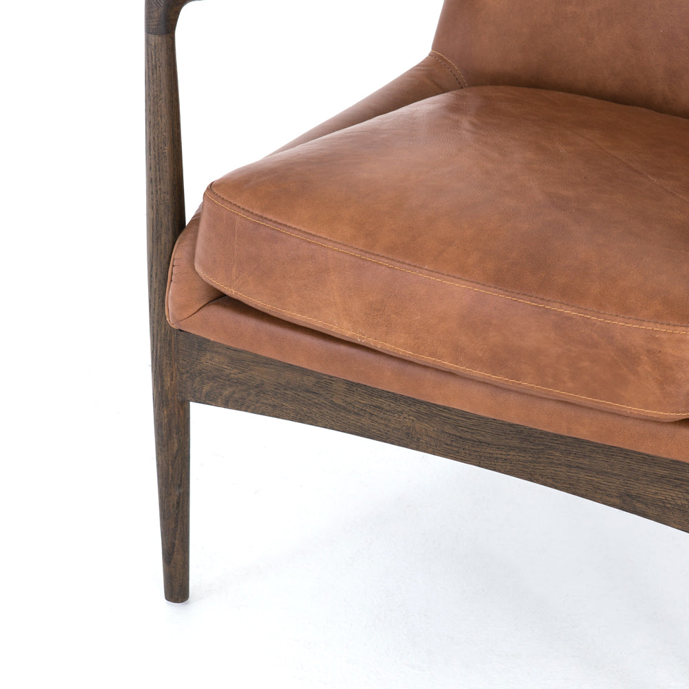 Dramatic arms and a deeper seat offer relaxation with mid-century modern sophistication. Sculpted nettlewood frame adds an architectural feel to brandy top-grain leather. Amethyst Home provides interior design, new construction, custom furniture, and area rugs in the Newport Beach metro area.