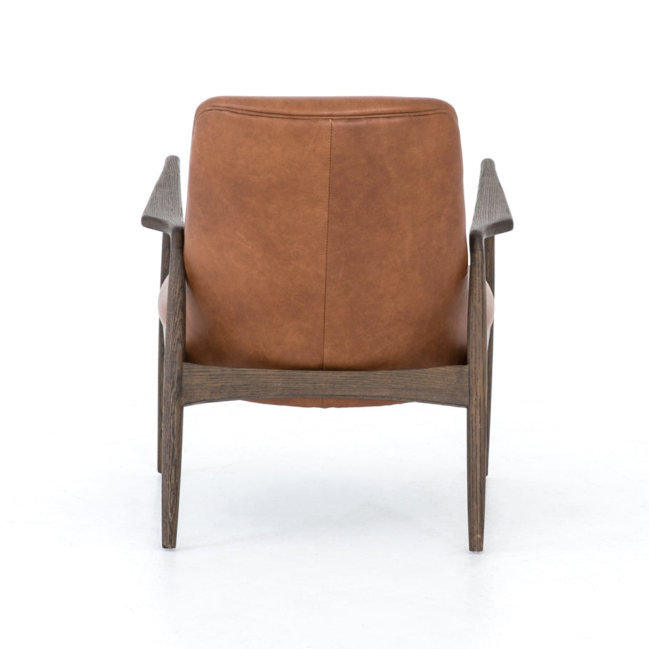 Dramatic arms and a deeper seat offer relaxation with mid-century modern sophistication. Sculpted nettlewood frame adds an architectural feel to brandy top-grain leather. Amethyst Home provides interior design, new construction, custom furniture, and area rugs in the Omaha metro area.