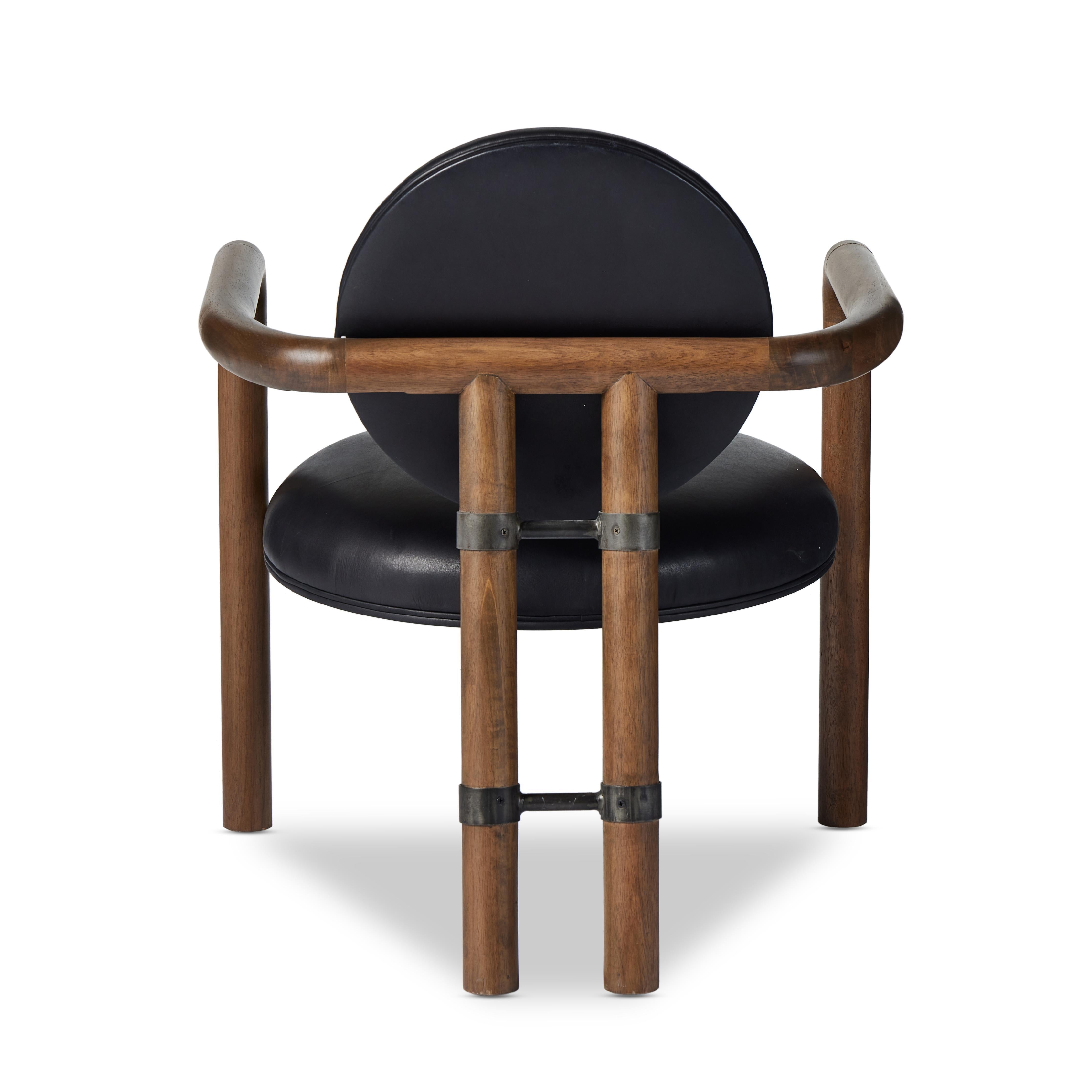 Featuring Bria Heirloom Black Chair by Four Hands at Amethyst Home. A playful take on Italian modernism. Solid parawood crafts a slim, curved frame and rear mock-tripod. Upholstered in black top-grain leather. Sourced from one of the oldest family-owned tanneries in Italy’s Bassano del Grappa, our heirloom leather covering is salvaged and processed from upcycle. Amethyst Home provides interior design, new home construction design consulting, vintage area rugs, and lighting in the Omaha metro area.