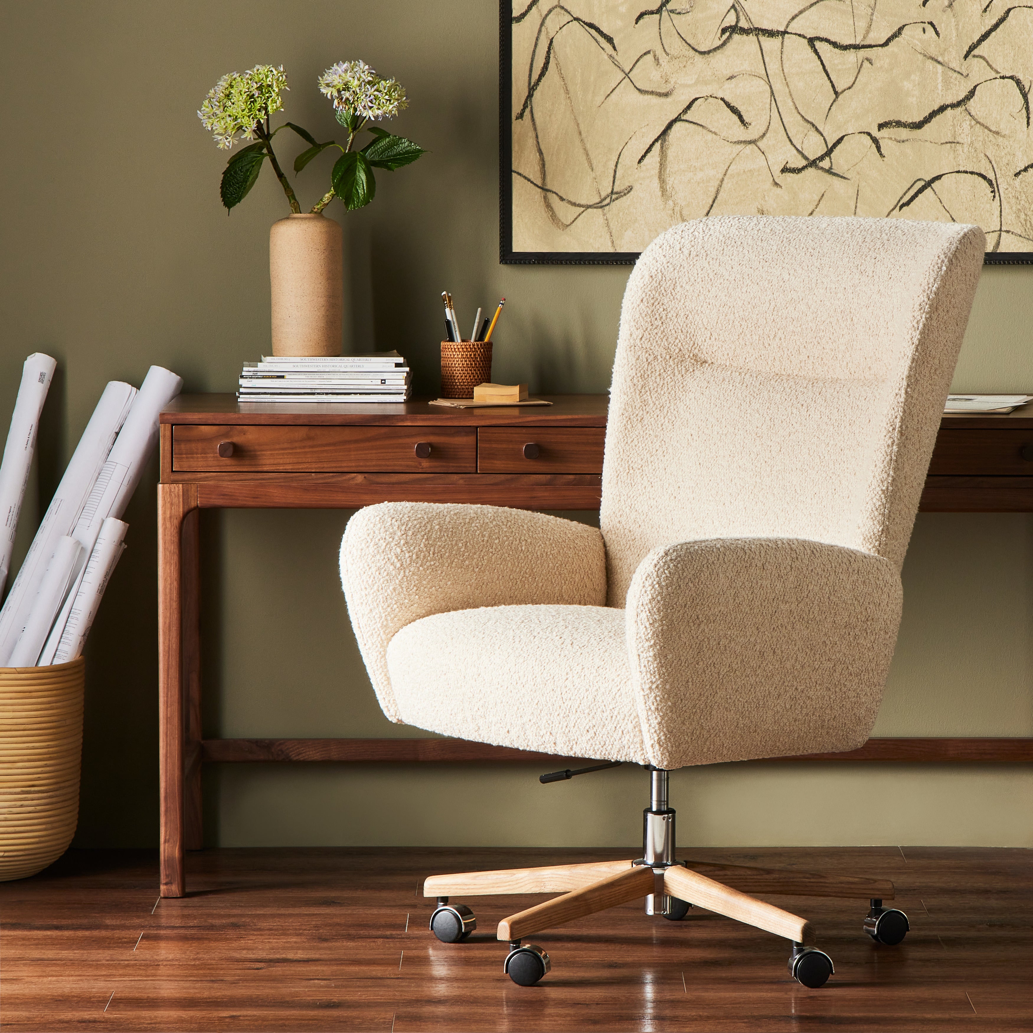 An executive-style chair is upholstered in a high-performance fabric, with subtle curves for a dramatic look and comfortable sit. Casters and seat heigh adjustability for ease in the modern office. Amethyst Home provides interior design, new construction, custom furniture, and area rugs in the Dallas metro area.
