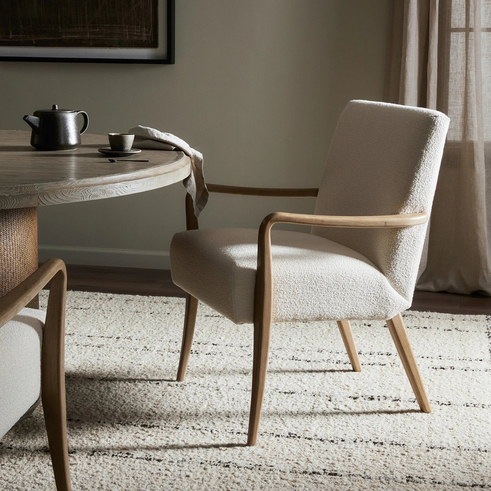Add timeless midcentury design to your table with this Danish-inspired dining chair. Fluid oak arms and cream upholstery create a chair that embodies both comfort and style.Collection: Ashfor Amethyst Home provides interior design, new home construction design consulting, vintage area rugs, and lighting in the Winter Garden metro area.