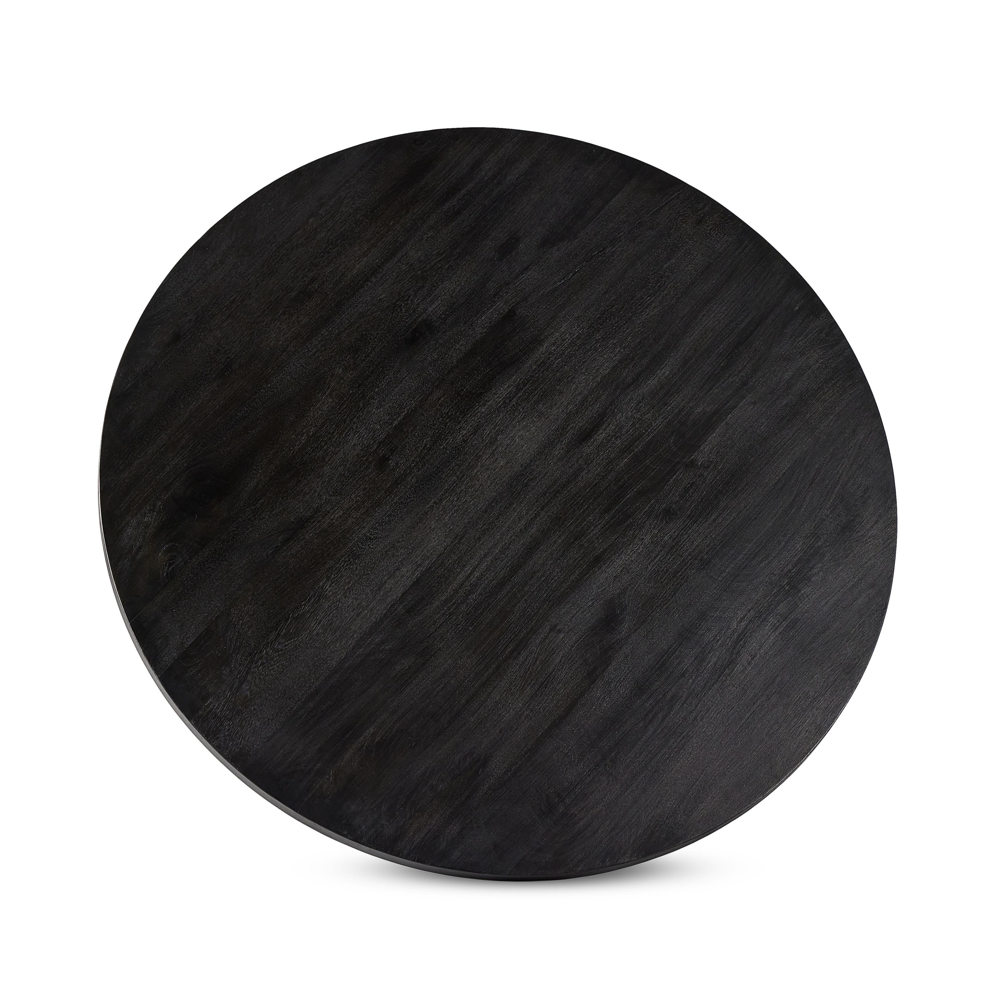 A rounded table of solid mango wood forms purposefully burnished edges, producing a warm black patina for the home dining table. Amethyst Home provides interior design, new construction, custom furniture, and area rugs in the Washington metro area.