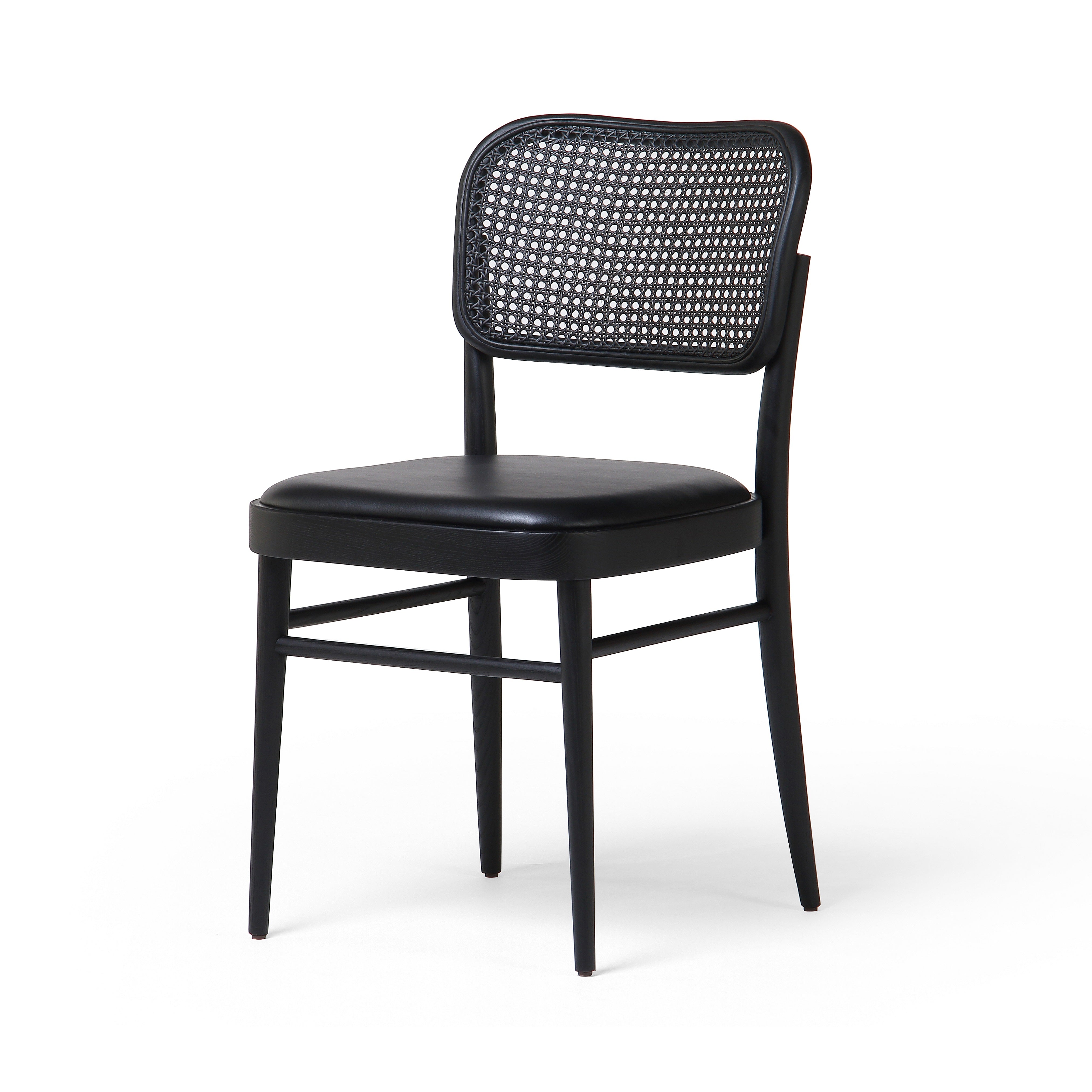 Inspired by the Thonet chair popularized in the mid-century, the Court Black Ash Dining Chair forms a simple but-shapely frame for black seating and a natural cane back. Amethyst Home provides interior design services, furniture, rugs, and lighting in the Dallas metro area.